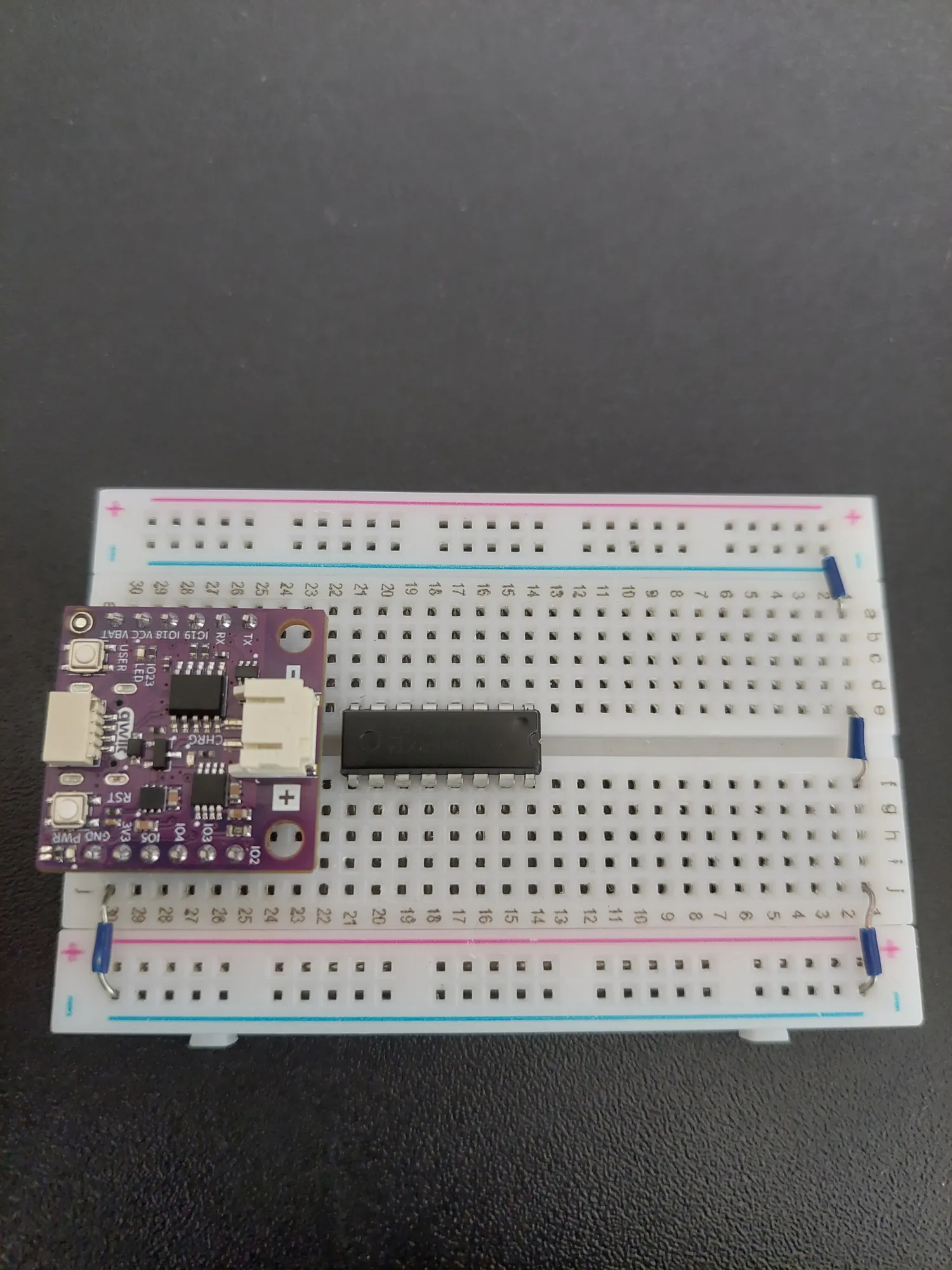 74HC595 pressed into the breadboard across the centre channel