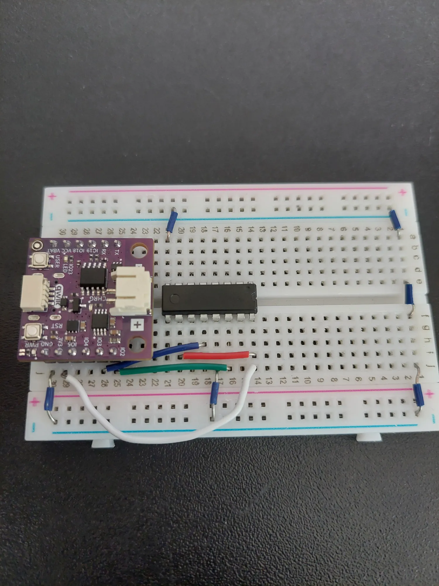 Dark blue wire connecting IO3 to the shift register latch pin