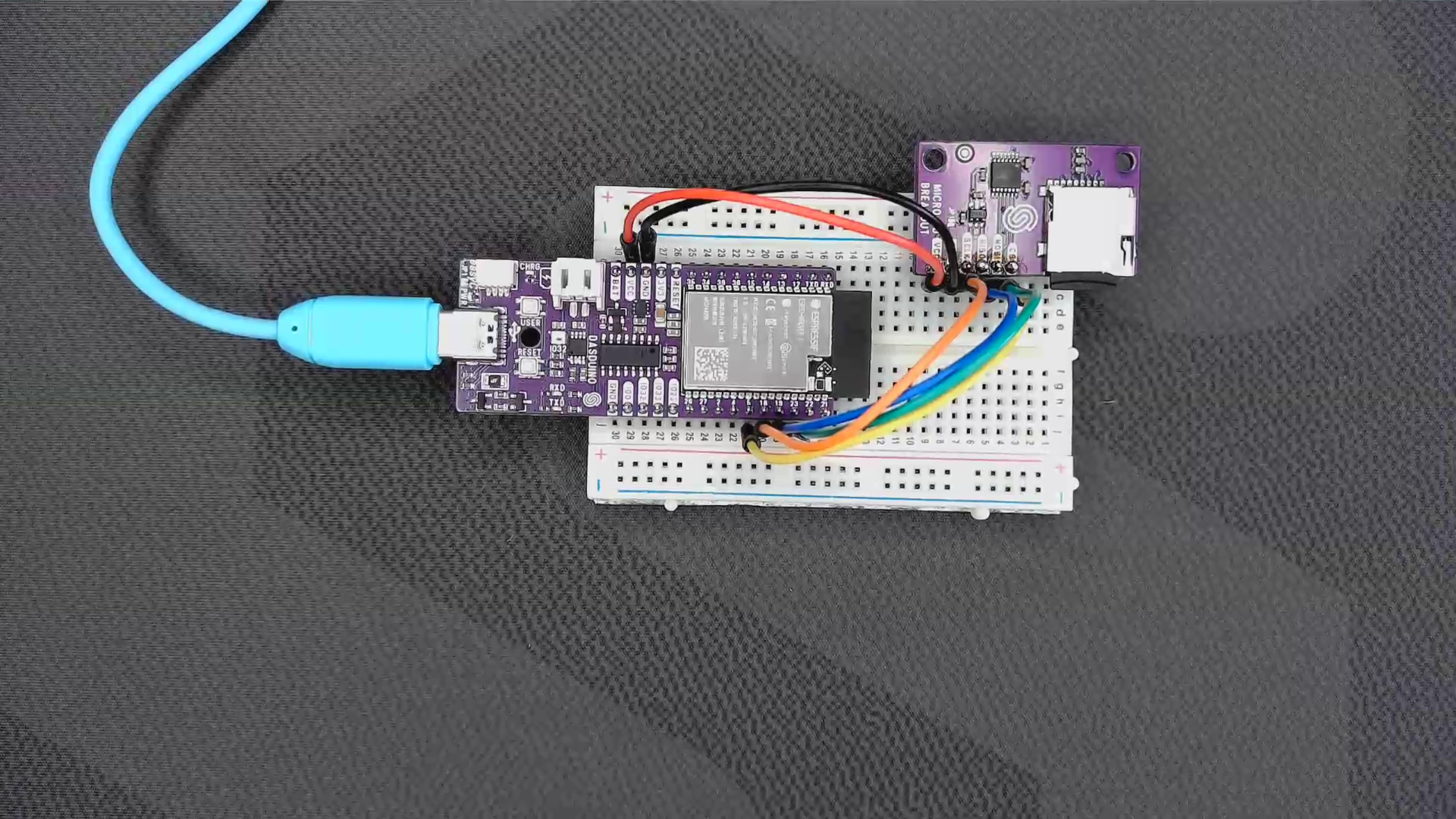 Soldered microSD card breakout wired to a NULA board on a breadboard with six jumper wires